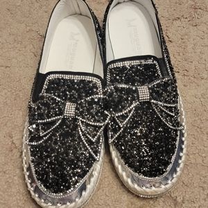 Black and white and silver slip on sneakers